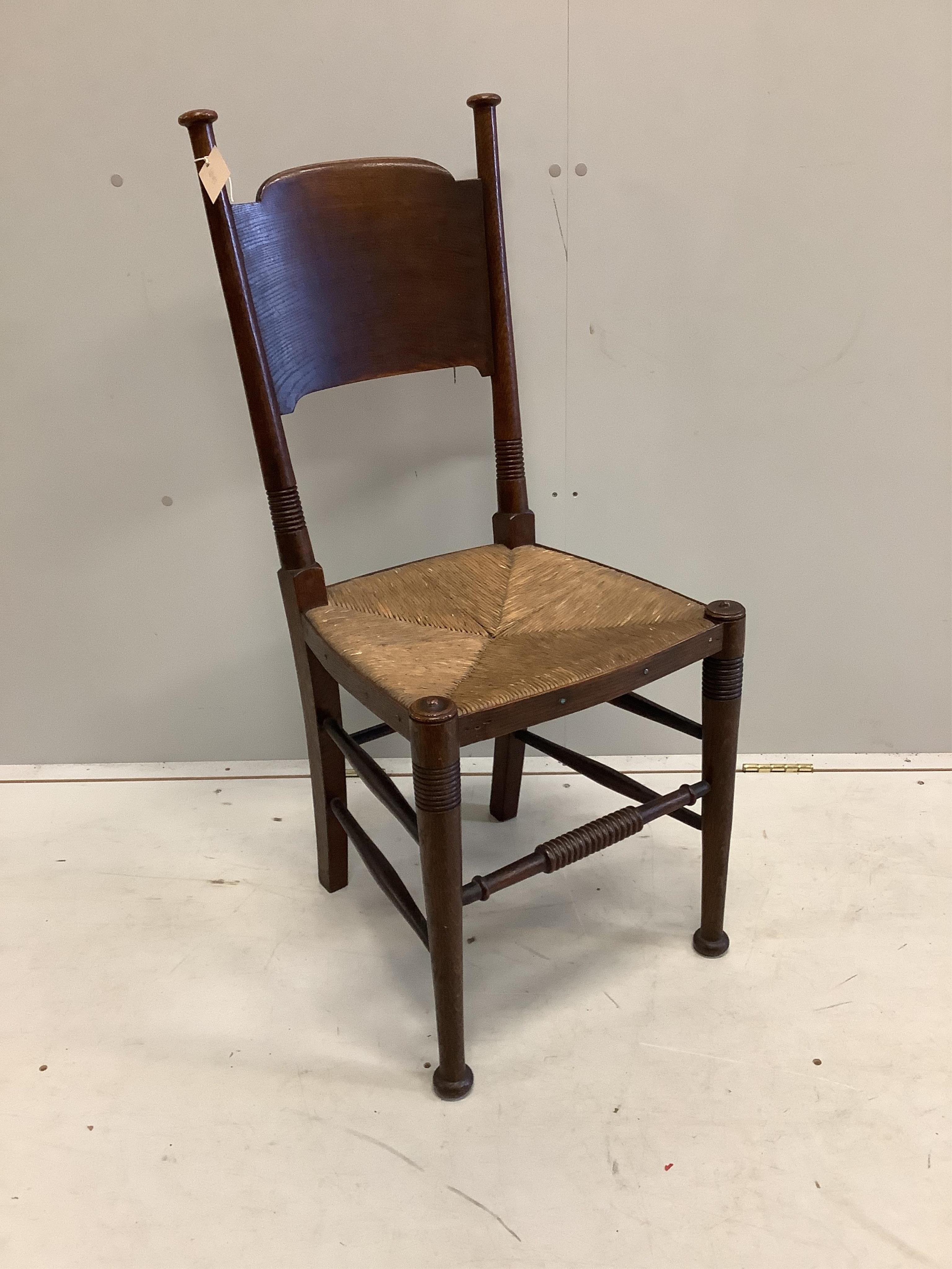 A Liberty & Co William Birch Arts and Crafts oak rush seat chair, width 40cm, depth 40cm, height 98cm. Condition - good.